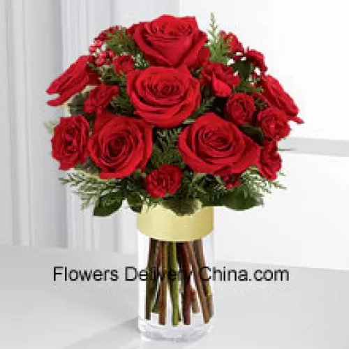 Send them the warmth and heartfelt sentiments expressed throughout the holiday season. Rich red roses and spray roses are offset by burgundy mini carnations, variegated holly stems and assorted holiday greens, beautifully arranged in a clear glass gold banded vase to bring your special recipient a merry moment they will treasure throughout the Christmas season. (Please Note That We Reserve The Right To Substitute Any Product With A Suitable Product Of Equal Value In Case Of Non-Availability Of A Certain Product)